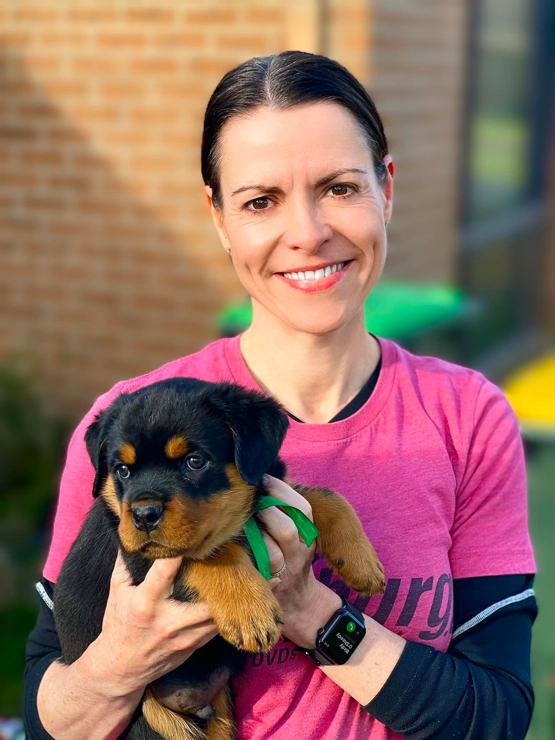 women smiling with puppy